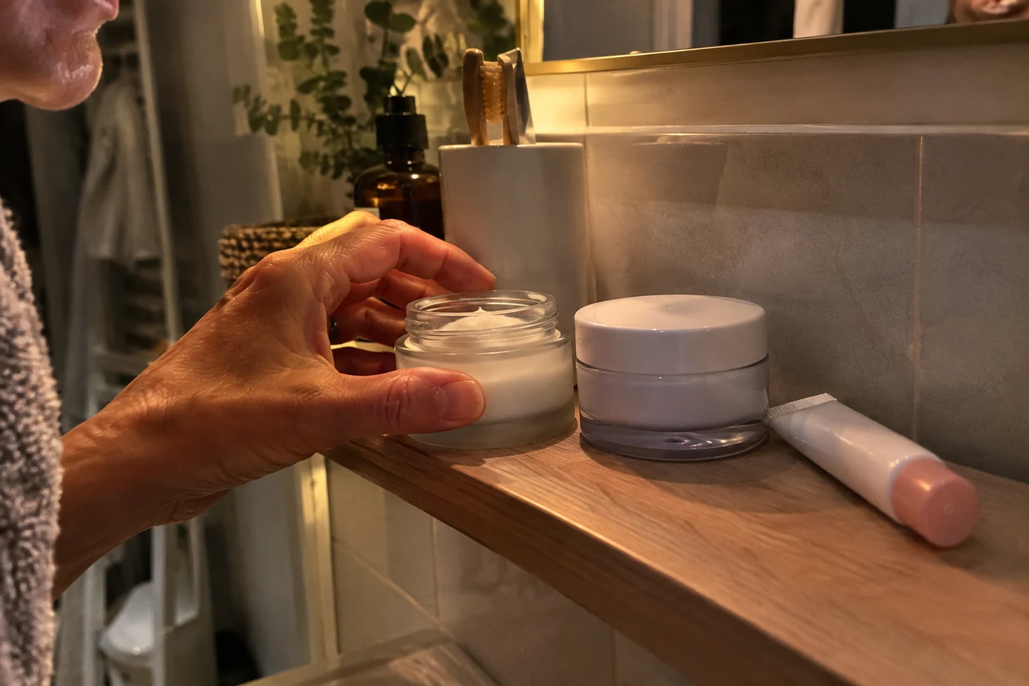 Une crème hydratante rangée sur une étagère de salle de bain